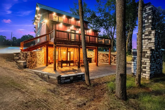 a backyard of a house with barbeque oven table and chairs