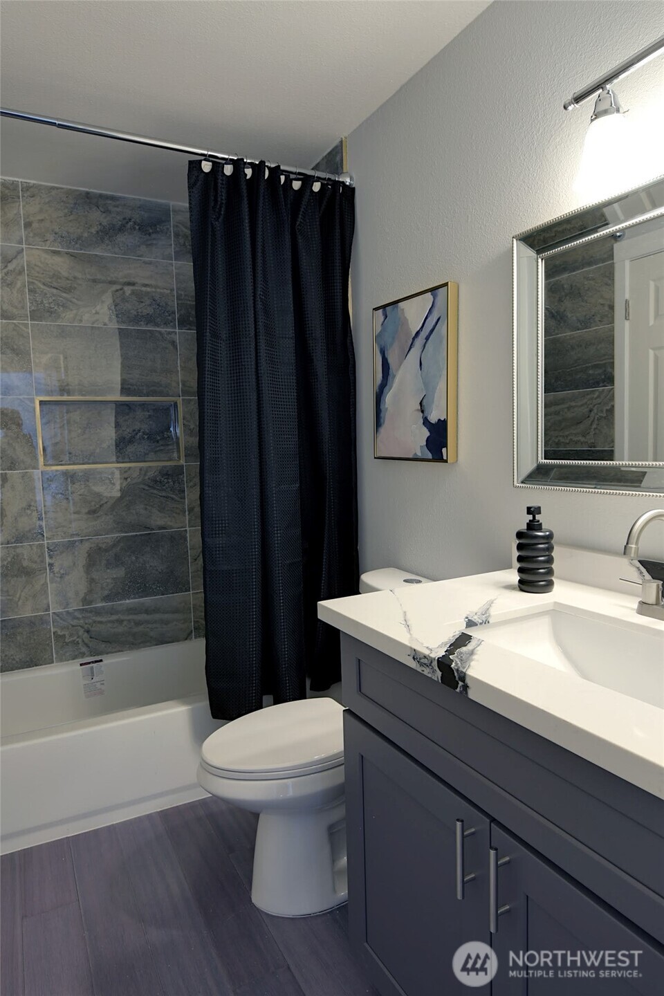 1555 Union Avenue Northeast, Unit G38 Renton, WA 98059 - Photo 11 of 18 a bathroom with a sink a toilet and shower