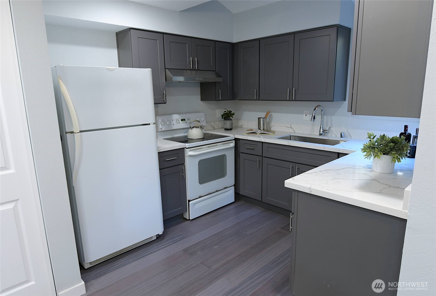 1555 Union Avenue Northeast, Unit G38 Renton, WA 98059 - Photo 4 of 18 a kitchen with a refrigerator sink and cabinets