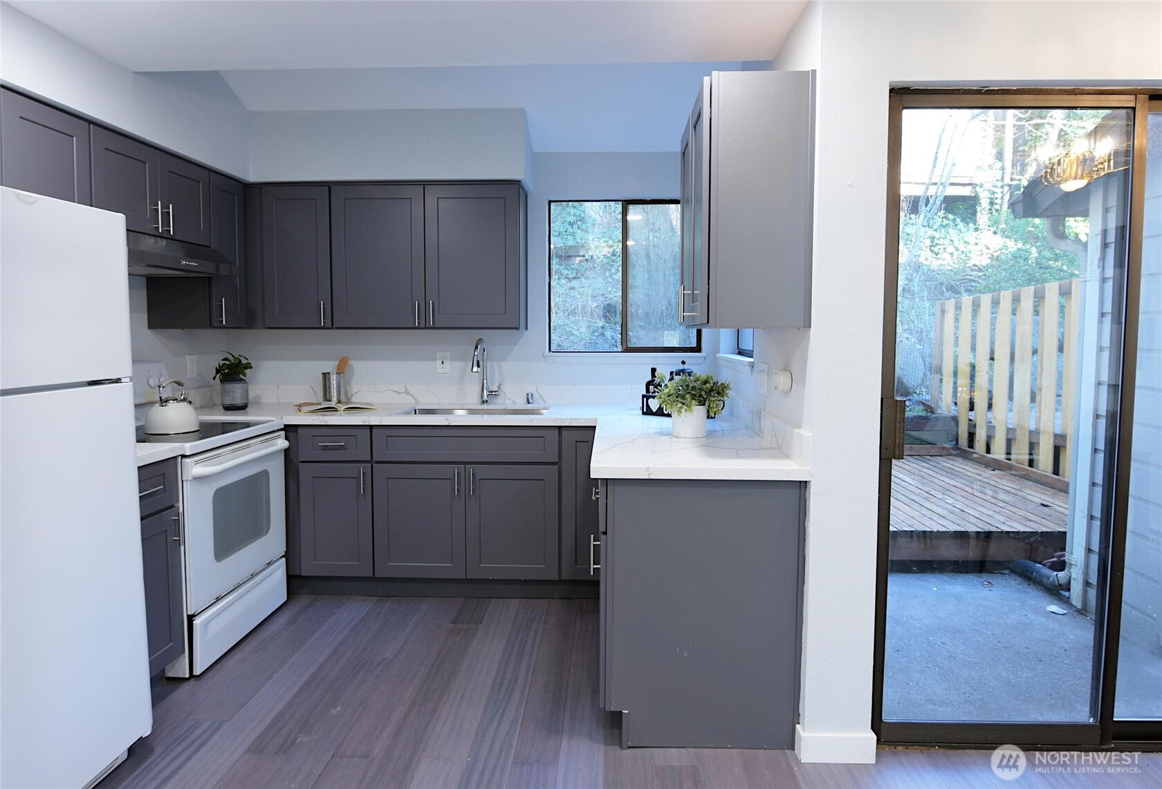 1555 Union Avenue Northeast, Unit G38 Renton, WA 98059 - Photo 5 of 18 a kitchen with a sink cabinets and wooden floor