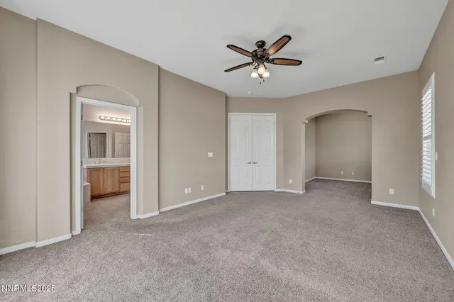 a view of a livingroom with a ceiling fan and window