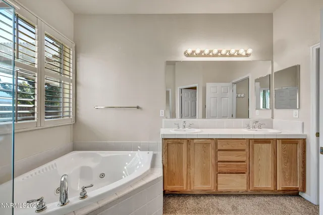 a white bath tub sitting next to a shower
