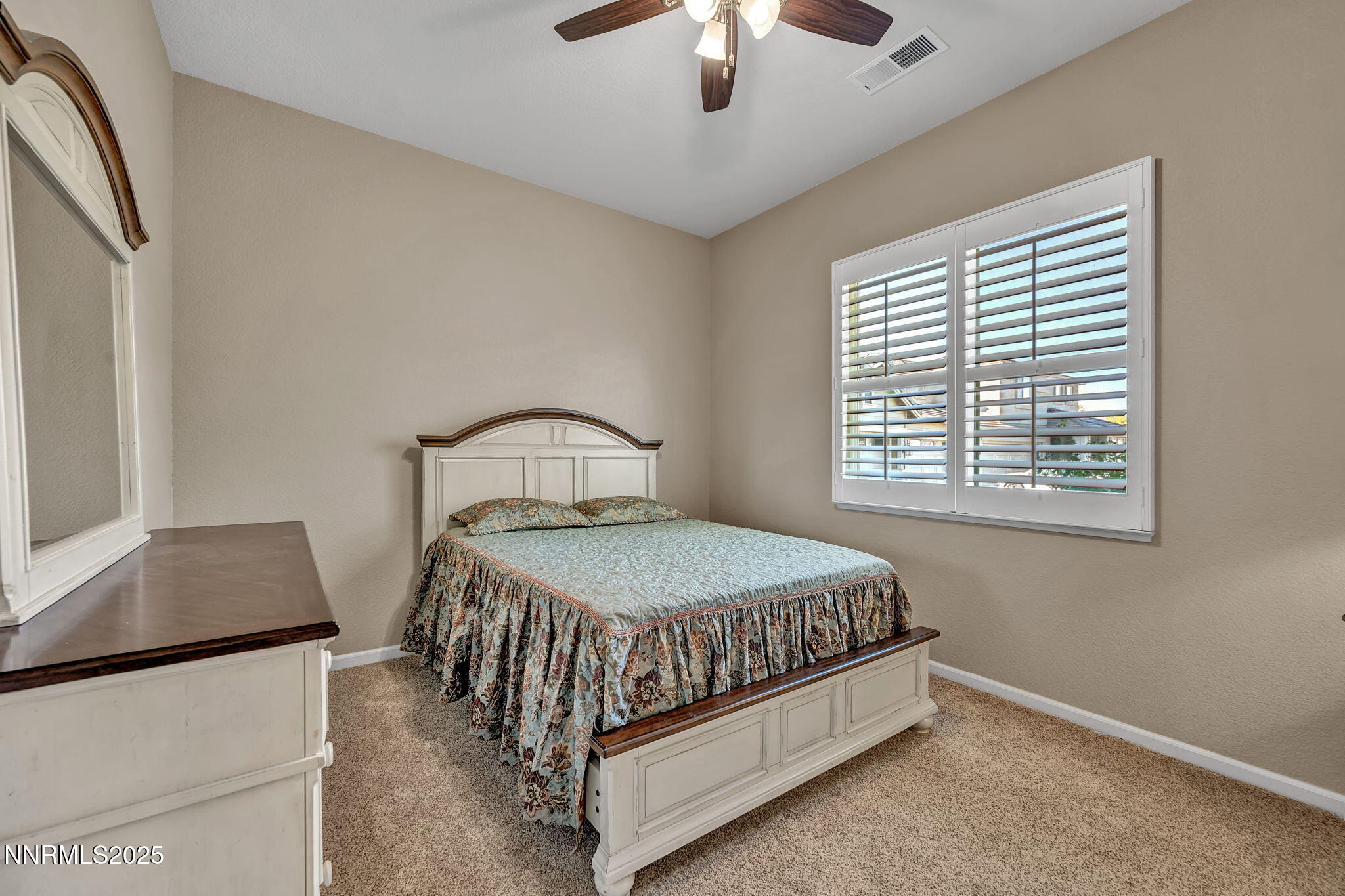 823 Gullane Court Dayton, NV 89403 - Photo 29 of 60 a bedroom with a bed window and a chandelier