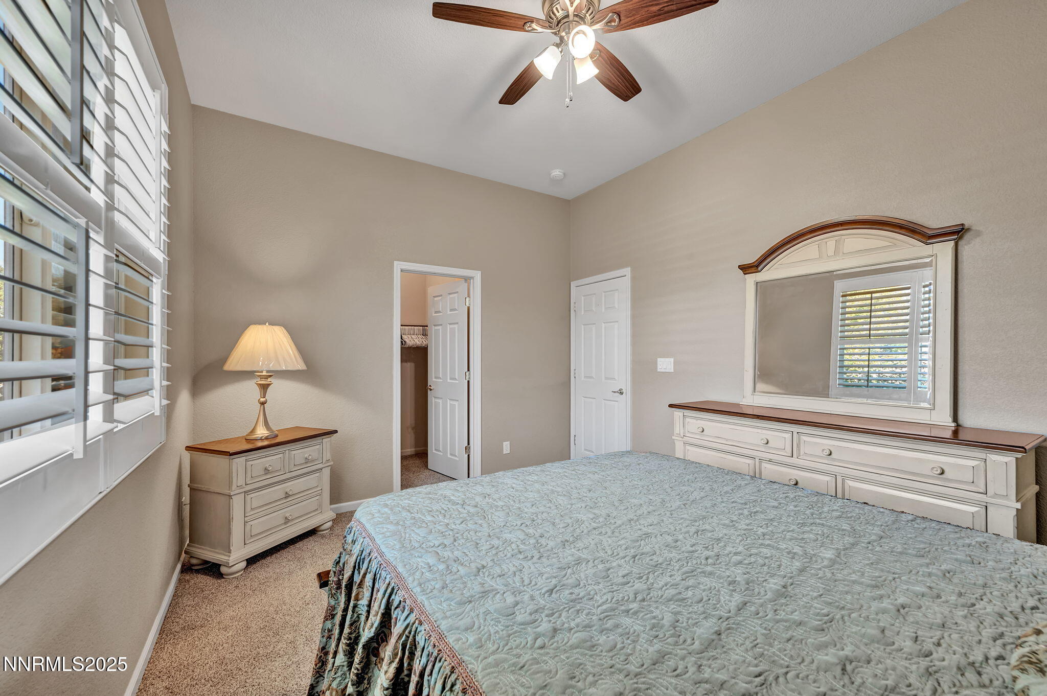 823 Gullane Court Dayton, NV 89403 - Photo 30 of 60 a bedroom with a bed and a chandelier