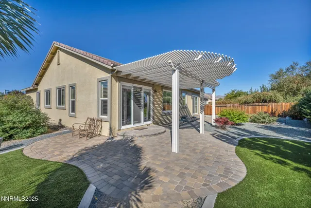 a view of a backyard with plants and a fountain
