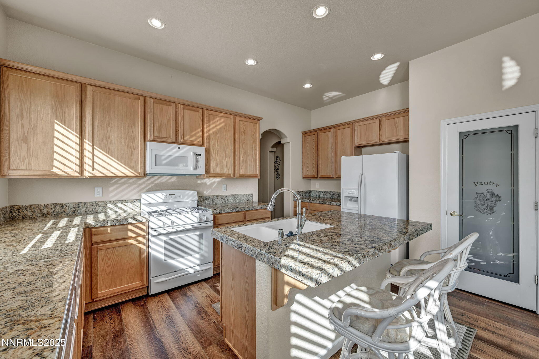 823 Gullane Court Dayton, NV 89403 - Photo 5 of 60 a kitchen with stainless steel appliances granite countertop a sink stove and refrigerator