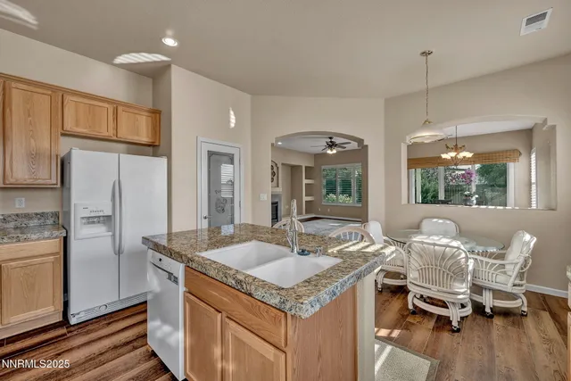 a kitchen with kitchen island granite countertop a sink and a granite counter tops