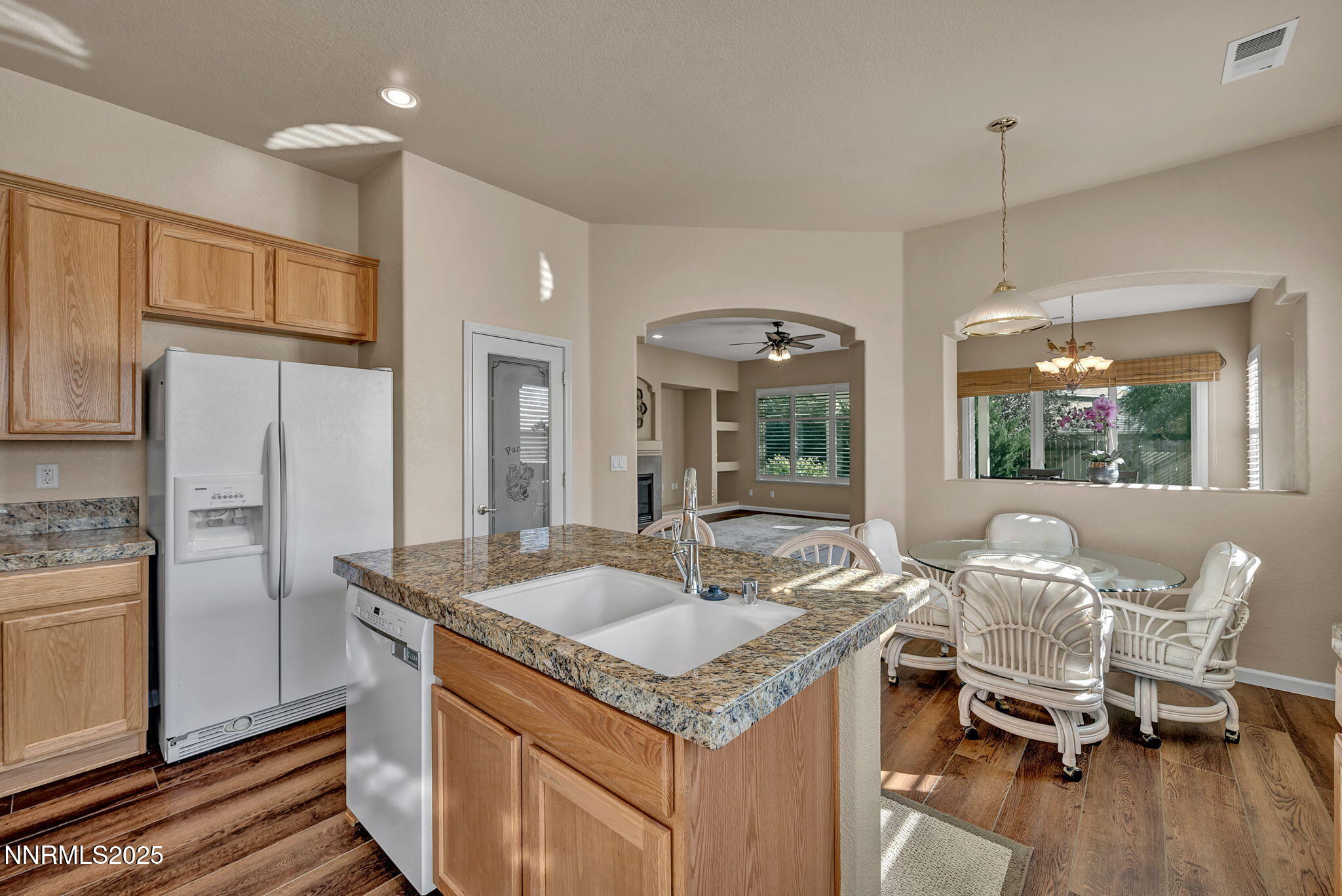 823 Gullane Court Dayton, NV 89403 - Photo 7 of 60 a kitchen with granite countertop a sink stove and refrigerator