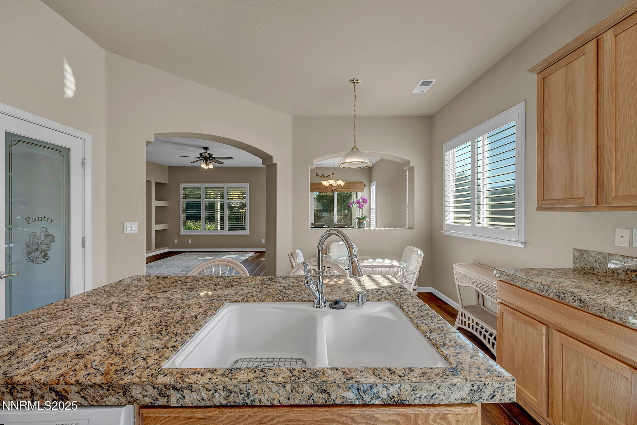 823 Gullane Court Dayton, NV 89403 - Photo 9 of 60 a kitchen with kitchen island granite countertop a sink and a granite counter tops