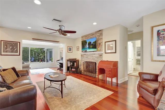 a living room with furniture a fireplace and a table