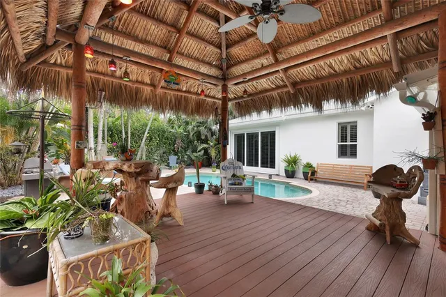 a view of a chairs and table in patio with a fire pit