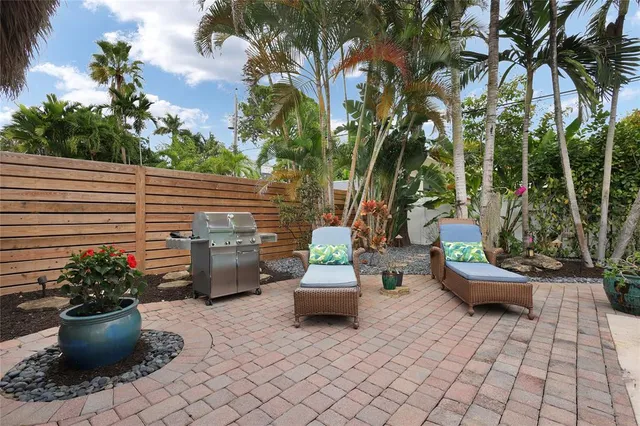 a view of a patio with chairs and plants