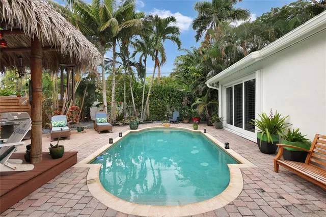 a view of a swimming pool with sitting area