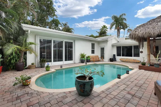 a view of a house with swimming pool and sitting area