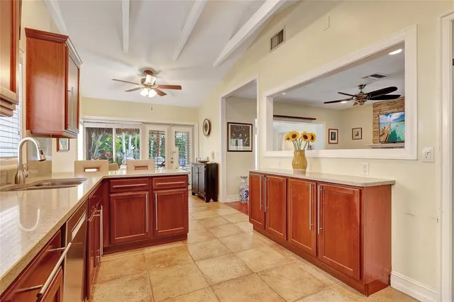 a large kitchen with stainless steel appliances granite countertop a sink and cabinets