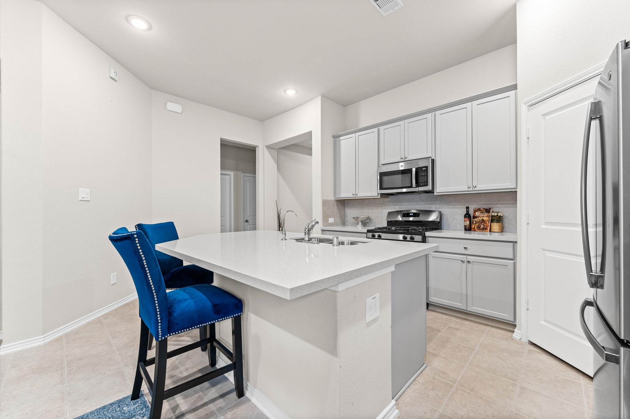 2702 Meadow View Lane Conroe, TX 77385 - Photo 17 of 26 a kitchen with stainless steel appliances a stove a sink refrigerator and a microwave