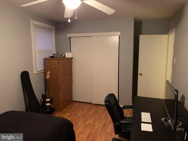 a bedroom with a bed and a mirror