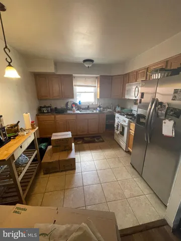 a kitchen with a sink and a stove top oven