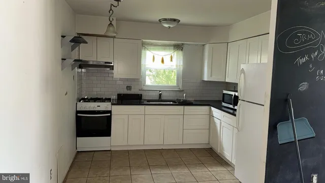 a kitchen with a refrigerator sink and stove