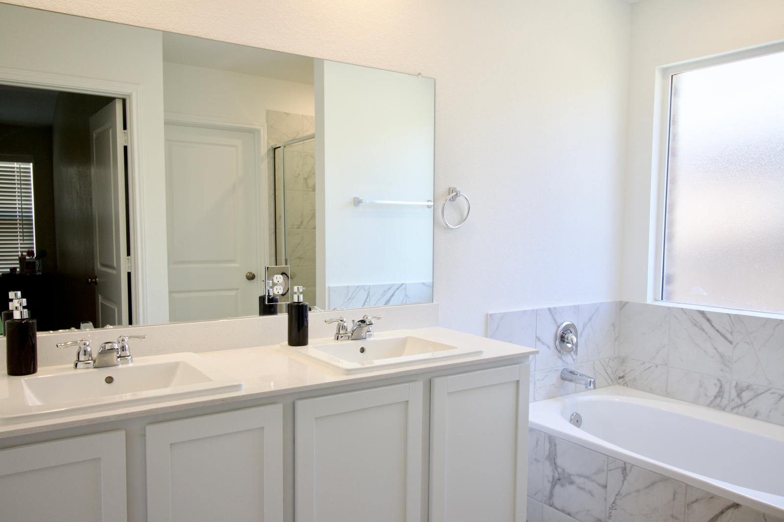 2545 Four Waters Loop Georgetown, TX 78628 - Photo 10 of 14 Double sinks and a deep soaking tub create a refined retreat.