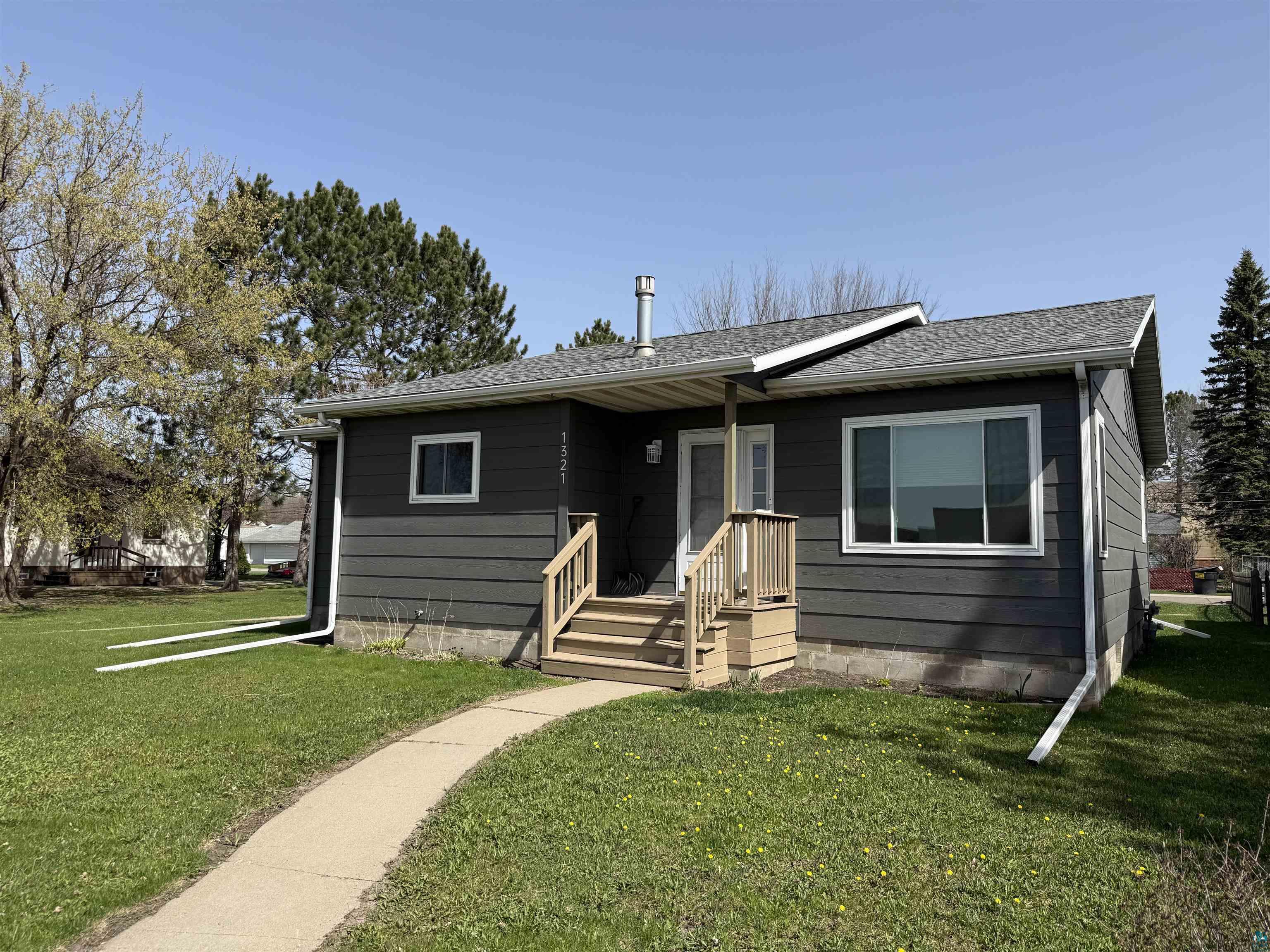 1321 South 13th Street Virginia, MN 55792 - Photo 2 of 33 Charcoal horizontal siding exterior with white trim windows and a new gray shingle roof