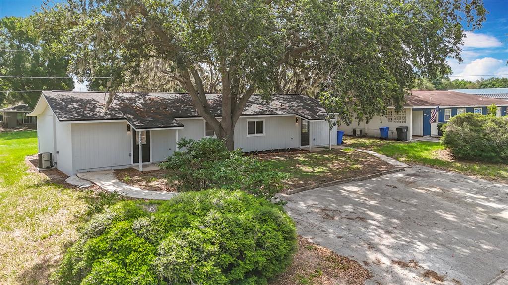 1305 Eagleview Drive Brandon, FL 33510 - Photo 3 of 27 a view of a backyard with plants and large tree