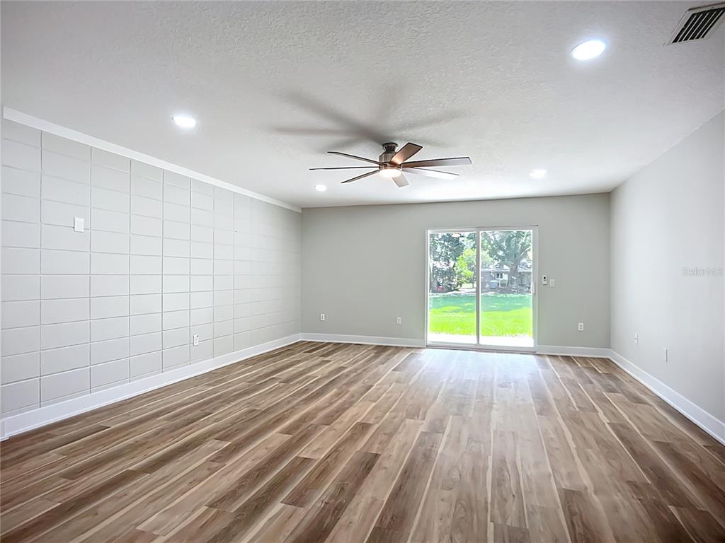 1305 Eagleview Drive Brandon, FL 33510 - Photo 8 of 27 a view of an empty room with a window and wooden floor