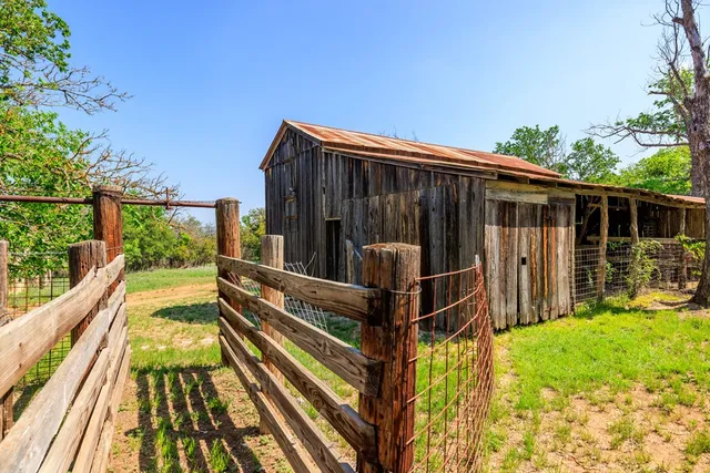 a view of balcony with wooden floor and fence
