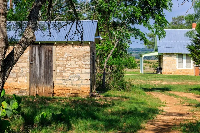 a view of house with backyard