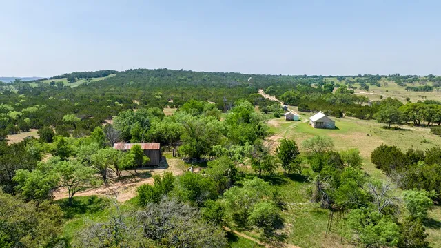 a view of a city with lush green forest