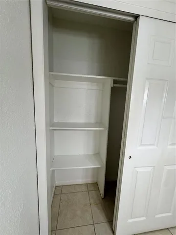 a view of a closet area with hardwood floor