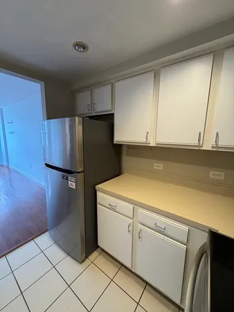 a utility room with cabinets washer and dryer