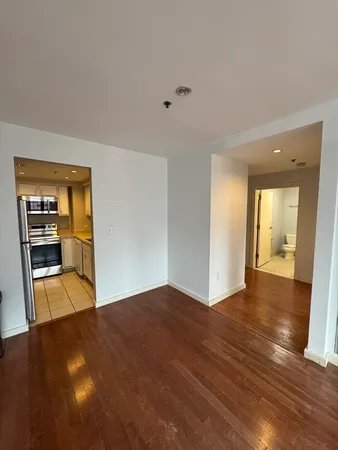 a view of a room with wooden floor and a window