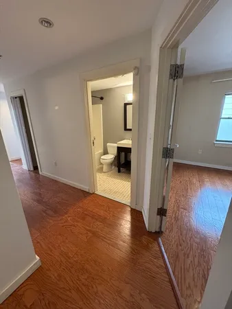 a view of a hallway view with wooden floor and staircase