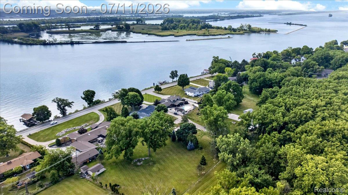 23750 East River Road Grosse Ile, MI 48138 - Photo 50 of 54 Expansive waterfront property featuring a substantial body of water, extensive green space, mature trees, and multiple residential structures