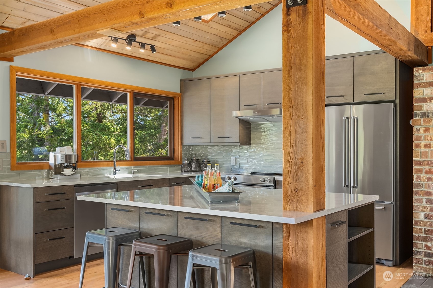 378 Smugglers Cove Road Shaw Island, WA 98286 - Photo 17 of 40 a kitchen with a sink and chairs