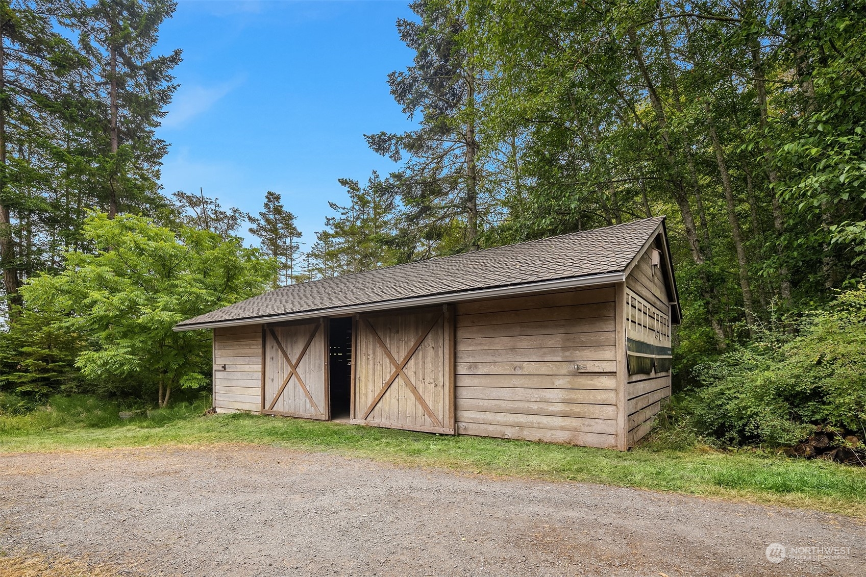378 Smugglers Cove Road Shaw Island, WA 98286 - Photo 34 of 40 a backyard of a house with lots of green space