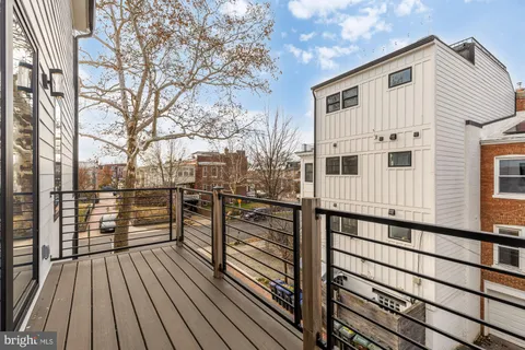 a view of a balcony with wooden floor and fence