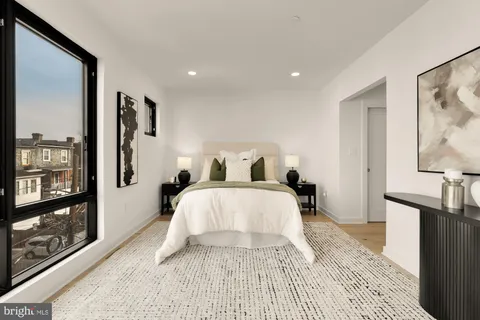 a bedroom with a large bed and a flat screen tv