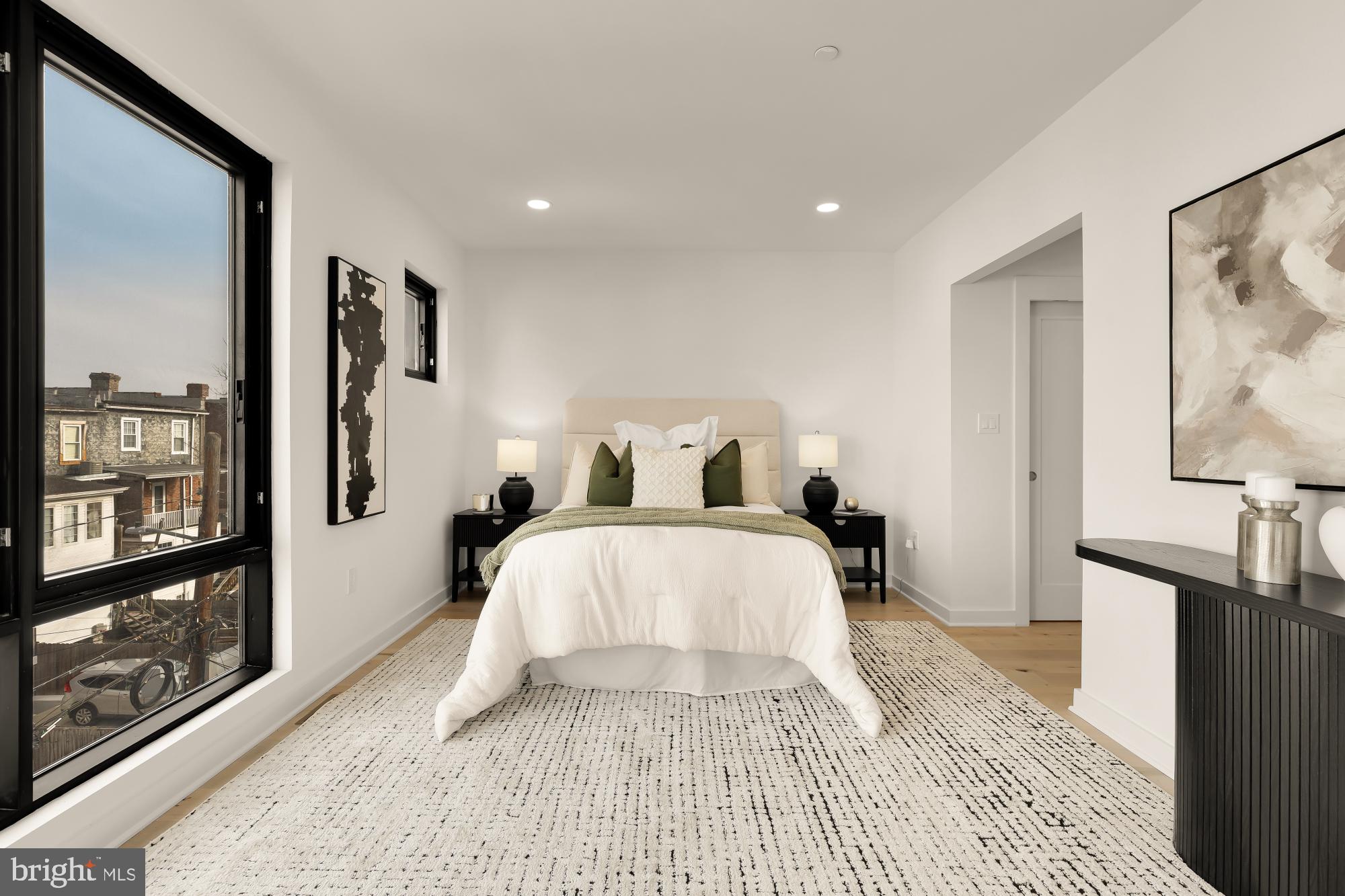 641 Quebec Place Northwest, Unit 2 Washington, DC 20010 - Photo 18 of 32 a bedroom with a large bed and a flat screen tv