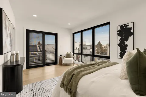 a bedroom with a large bed and a large window