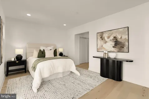 a bedroom with a bed and a painting on the wall