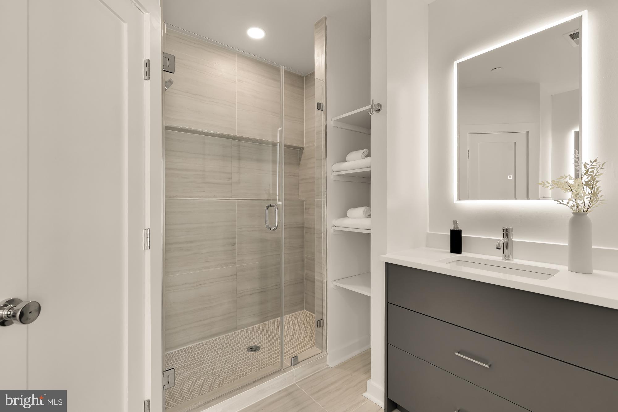 641 Quebec Place Northwest, Unit 2 Washington, DC 20010 - Photo 21 of 32 a bathroom with a shower sink and mirror