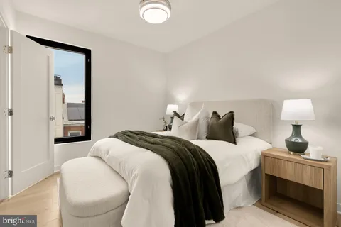 a bedroom with a bed and a lamp