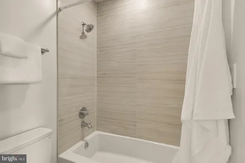 a bathroom with a shower and a bathtub