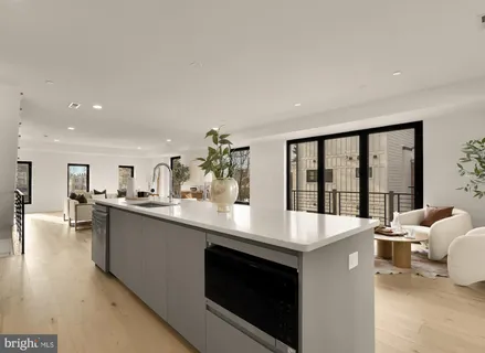 a large white kitchen with a large window
