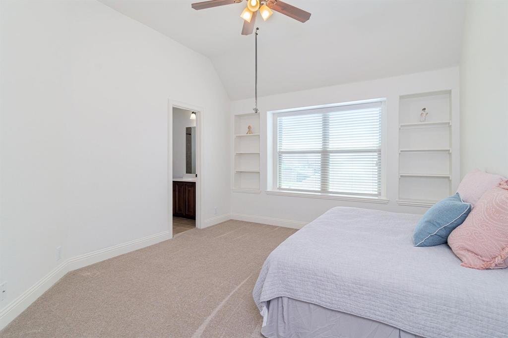 4210 Magnolia Road Melissa, TX 75454 - Photo 16 of 22 Vaulted ceiling, built-in shelving, ceiling fan with light fixture, window with blinds, and neutral carpet flooring