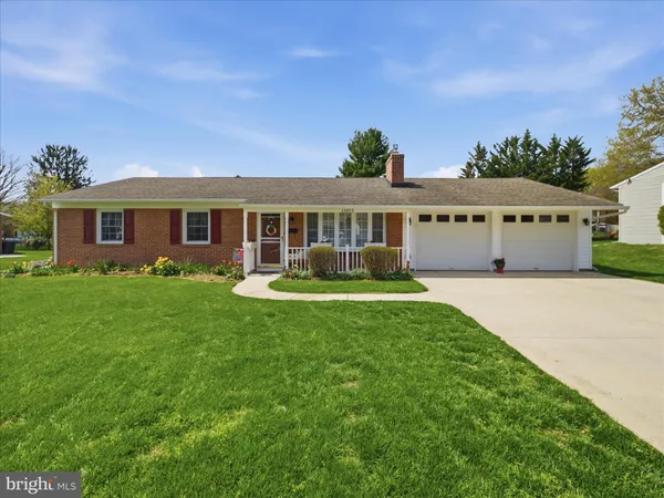 a front view of a house with a yard table and chairs