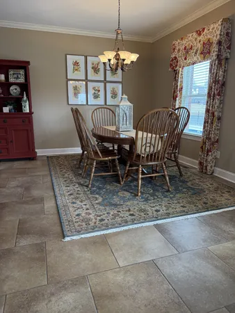 a dining room with furniture and window