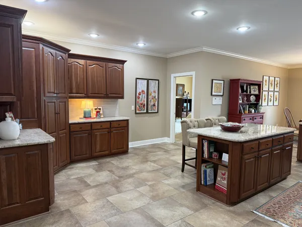 a kitchen with kitchen island a cabinets counter top space a sink stainless steel appliances and a center island